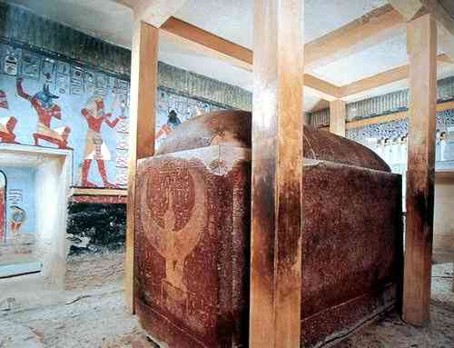 Burial chamber with sarcophagus and modern beams supporting the ceiling.